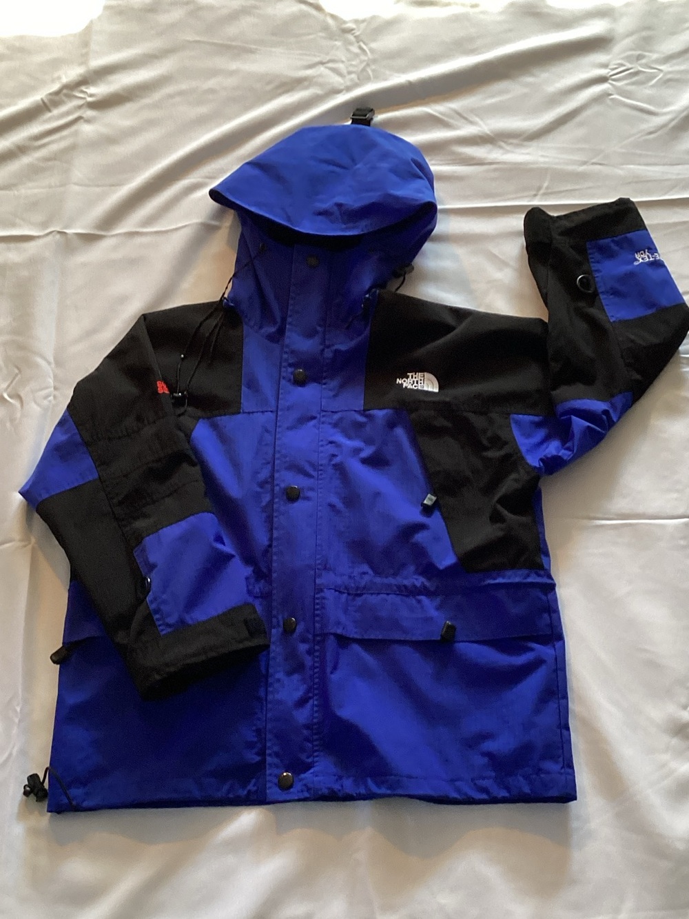 The North Face Kids Blue and Black Hooded Rain Jacket